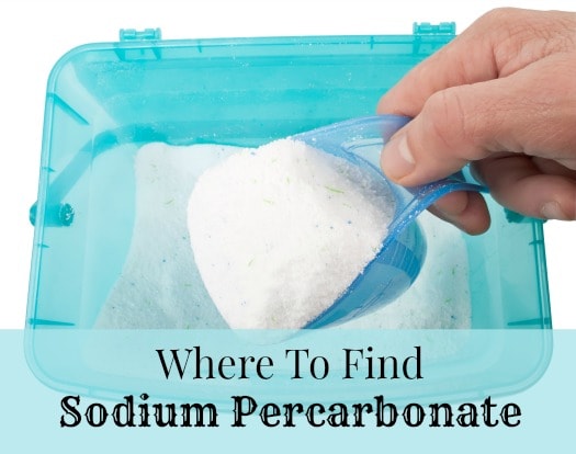 A hand scooping oxygen bleach, the main use of sodium percarbonate 