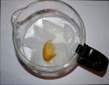 glass coffee pot with visible ice and lemon in it